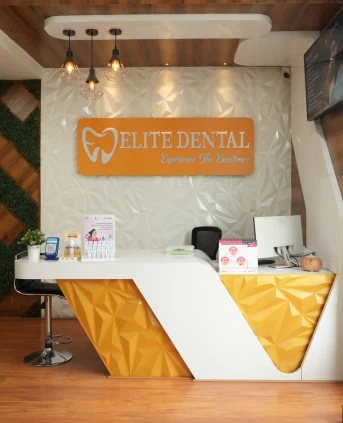 The reception desk at Elite Dental Clinic in Kondapur, with the clinic sign on the wall