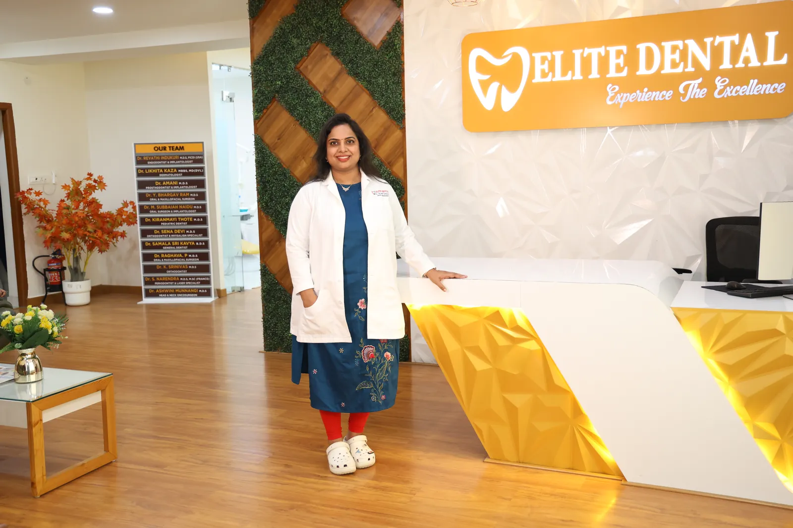 The reception at Elite Dental Clinic in Kondapur with Dr. Revathi Indukuri standing beside the desk
