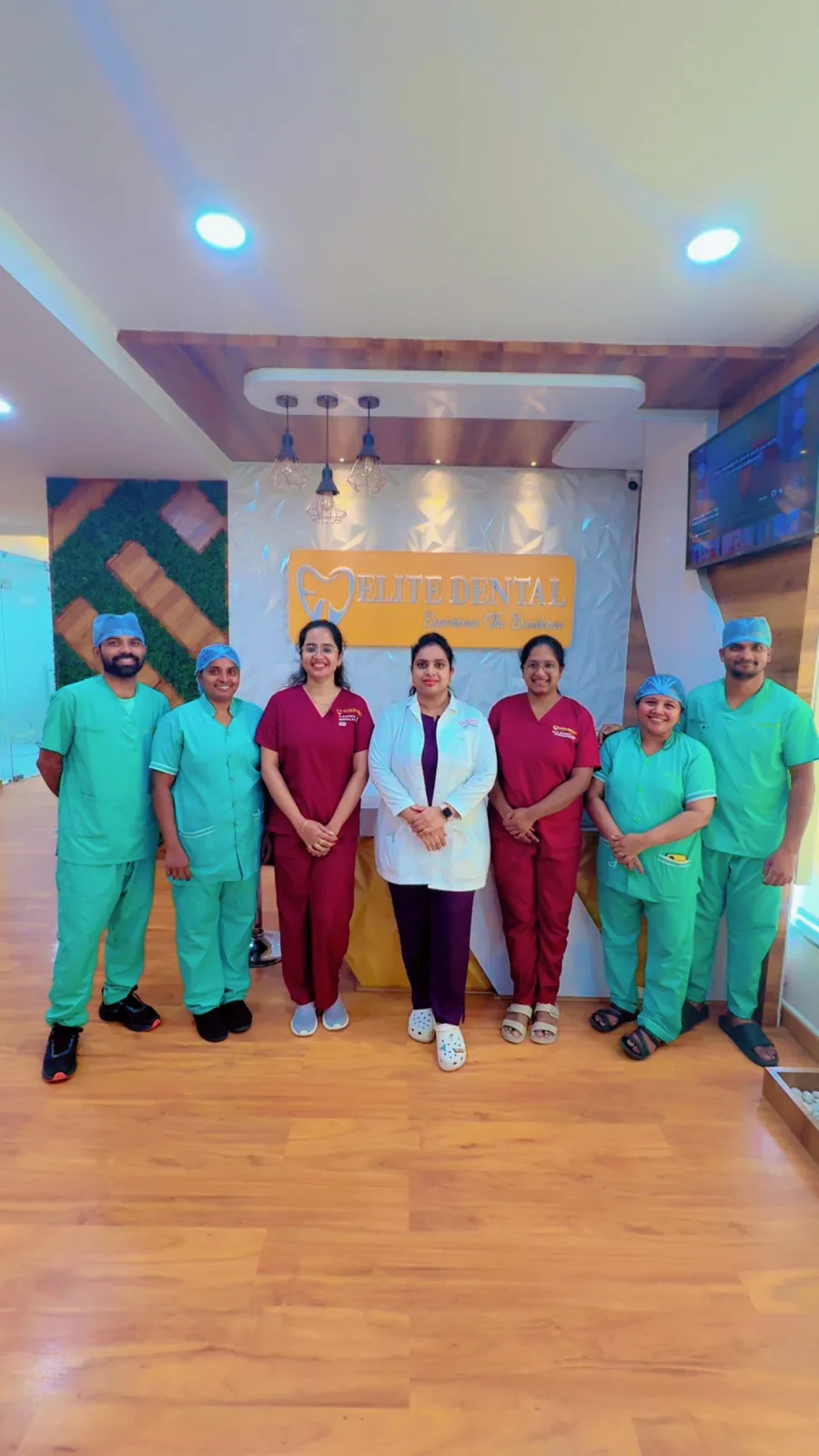 The Elite Dental Clinic team in scrubs standing together in the clinic in Kondapur
