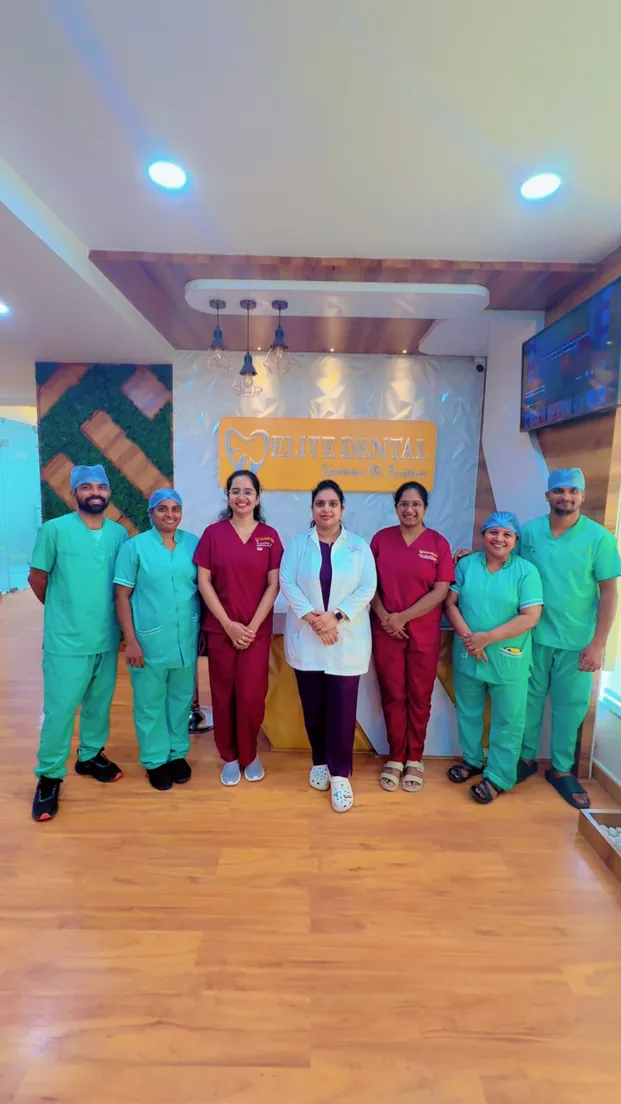 The Elite Dental Clinic team standing together in the clinic corridor in Kondapur